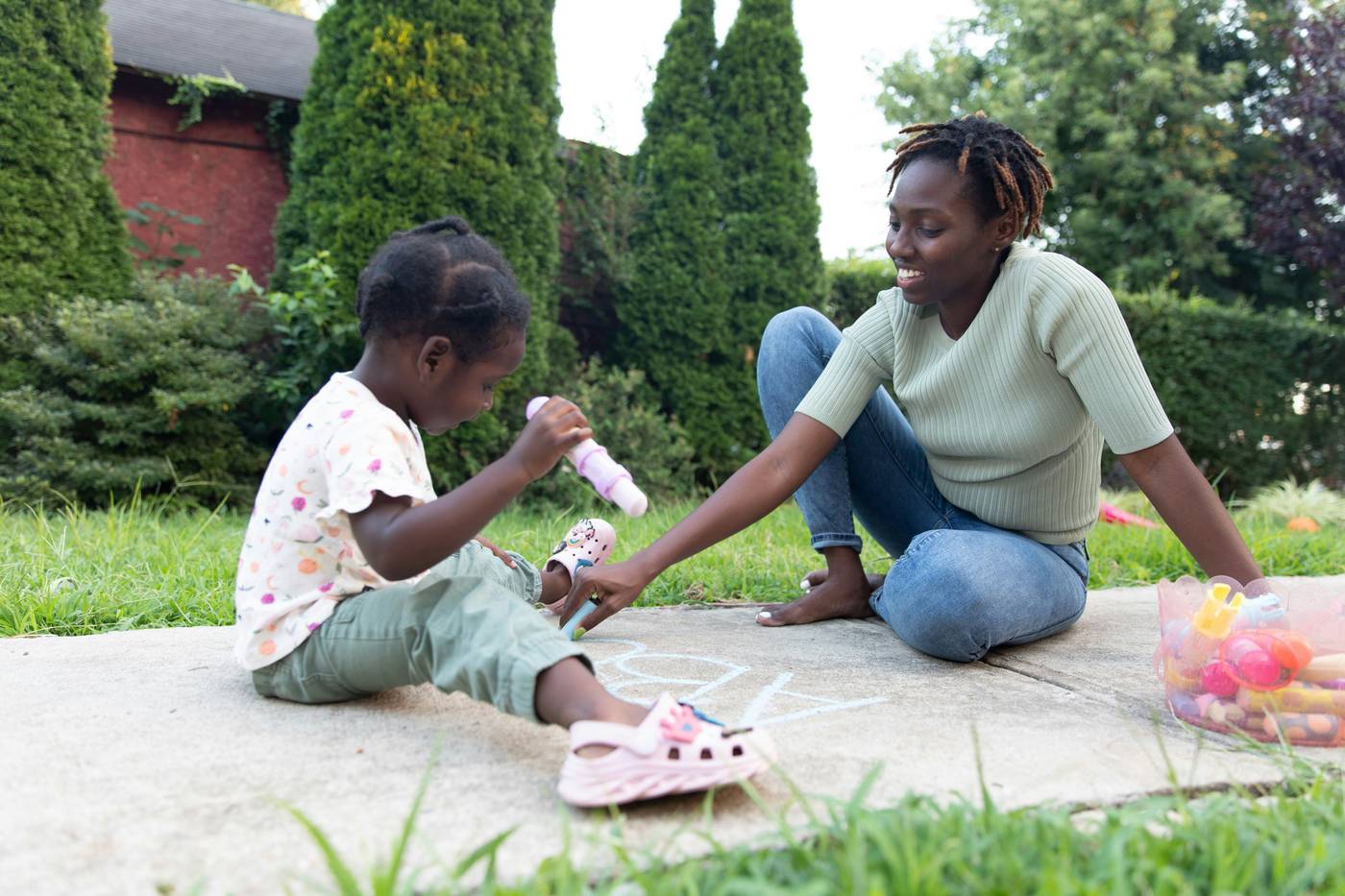 Mother and child drawing with chalk